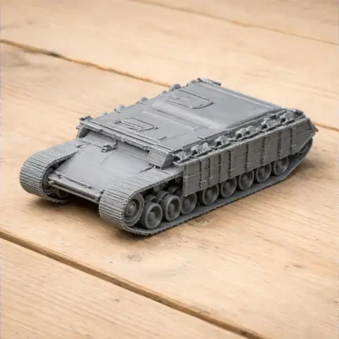 Gray 3D-printed model of a Nakpadon tank, detailed with tracks and armor, on a wooden surface.