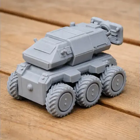 Gray 3D-printed six-wheeled robotic tank model with angular design and detailed surface features.