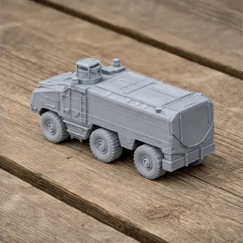 Gray 3D-printed model of a six-wheeled armored vehicle on a wooden surface.
