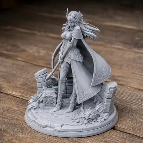 A detailed figure of a female warrior with a cape and a staff, standing on a decorated base.