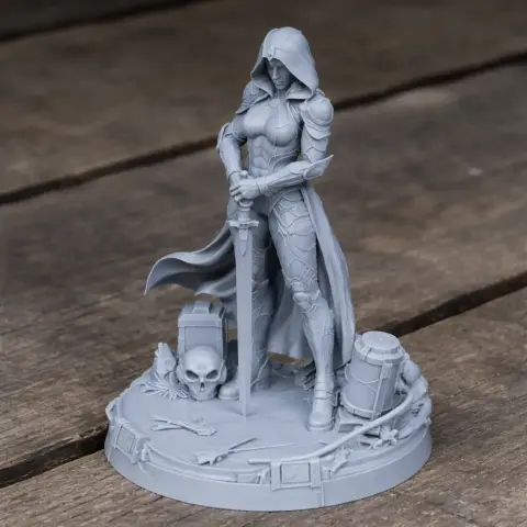Hooded warrior figure with armor and sword on a base with a skull and other items, ready for 3D printing.