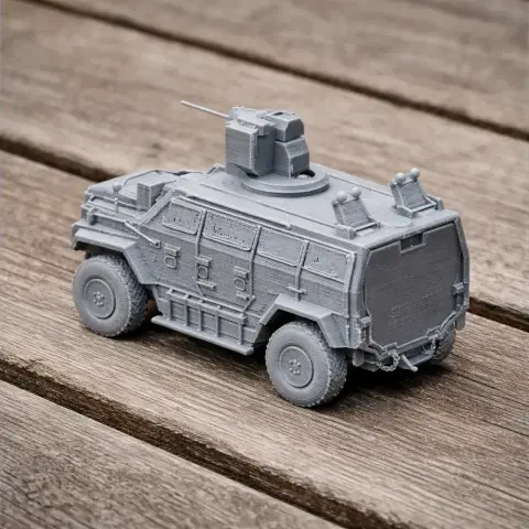 A detailed 3D printed model of a Nurol Ejder armored vehicle on a wooden surface.