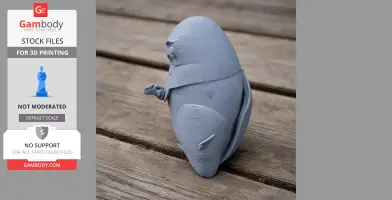 A gray 3D-printed model of a Banggai scops owl on a wooden surface.