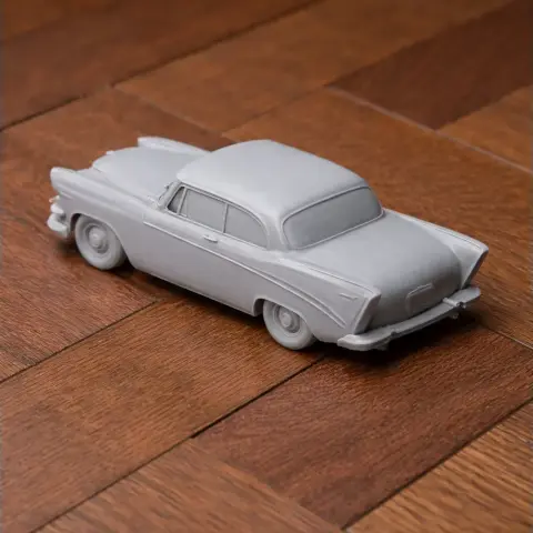 A detailed 3D-printed model of a classic Dodge Lancer car on a wooden surface.