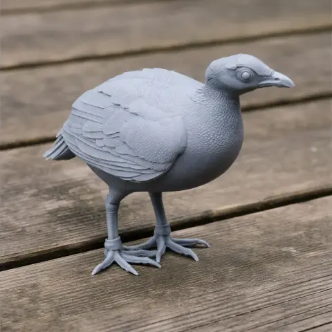 A gray 3D-printed model of a prehistoric bird with detailed feathers and feet, displayed on a wooden surface.