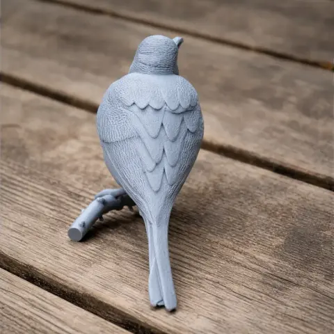 3D-printed model of a bird perched on a branch, showcasing detailed feathers and texture.