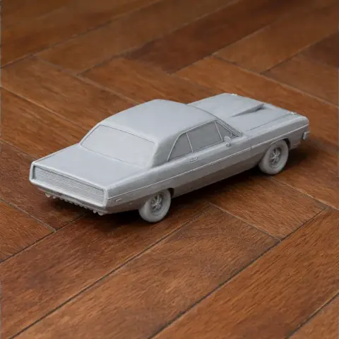 3D-printed model of a classic Dodge Swinger car on a wooden surface.
