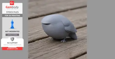 Gray 3D-printed bar-tailed trogon figurine on a wooden surface, featuring a smooth, rounded design.