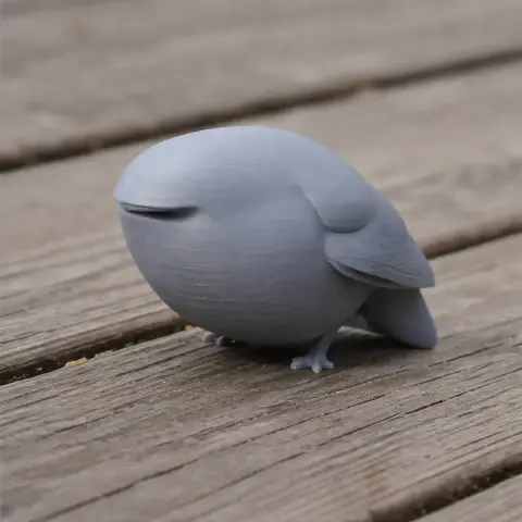 A smooth, simplified 3D model of a bird with minimal details, sitting on a wooden surface.