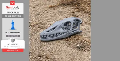 3D printed water monitor skull model displayed on gravelly ground.