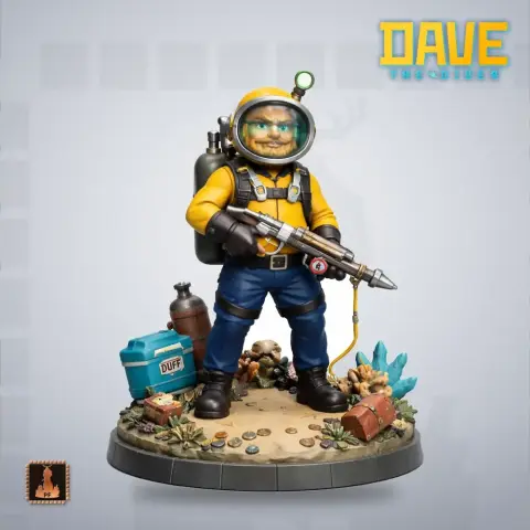 A diver figure in yellow gear with helmet and gear, standing on a sandy base with ocean-themed items.