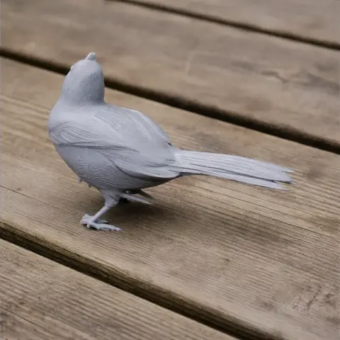 3D printed model of a bird with detailed feathers, standing on wooden planks.