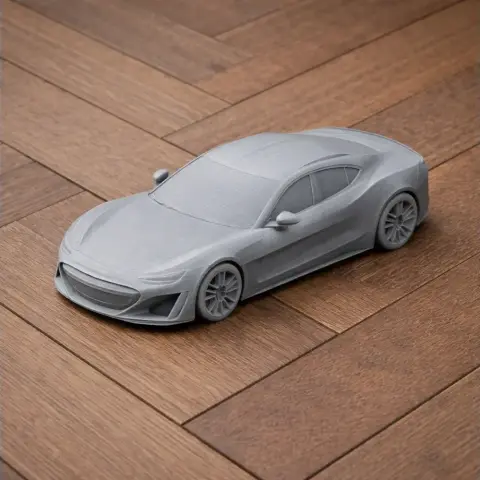Gray 3D-printed sports car model on a wooden surface.