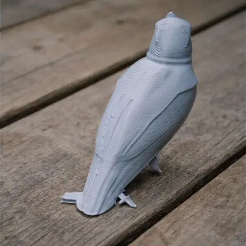 3D printed model of a bird with distinct wing patterns, displayed on a wooden surface.