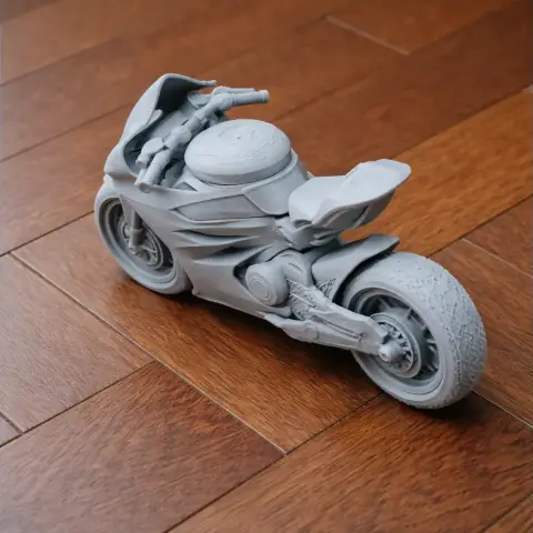 3D printed model of a Ducati Panigale V4 motorcycle on a wooden floor.