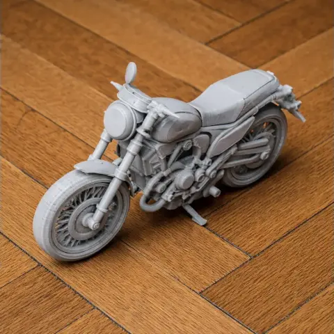 3D printed Ducati Scrambler motorcycle model on wooden floor.