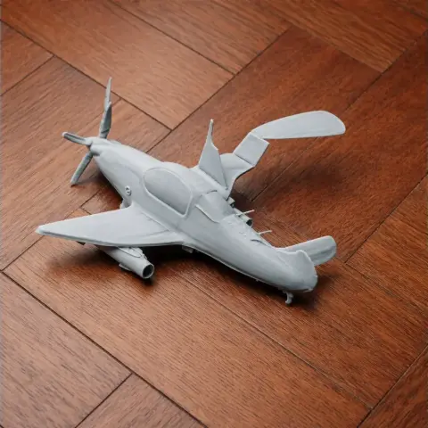 3D-printed model of a small aircraft with sleek, modern design on a wooden surface.
