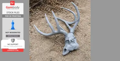 3D printed white-tailed deer skull replica with antlers, lying on sandy ground.