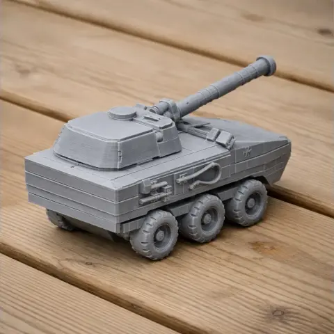 Gray 3D-printed model of a six-wheeled tank with a long cannon on wood surface.