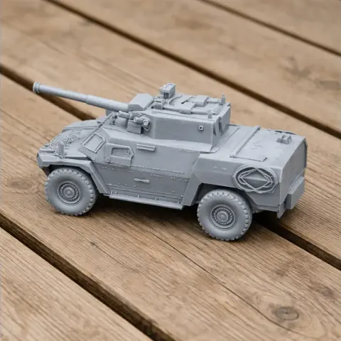 Gray 3D-printed model of an armored vehicle with a turret and wheels on a wooden surface.
