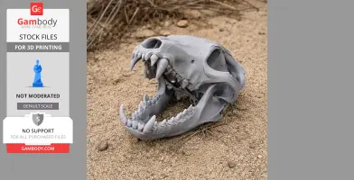 A detailed 3D-printed wolf skull replica lies on sandy ground.