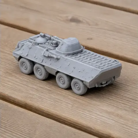 Detailed 3D-printed model of an OT-64 SKOT armored tank with six wheels, displayed on a wooden surface.