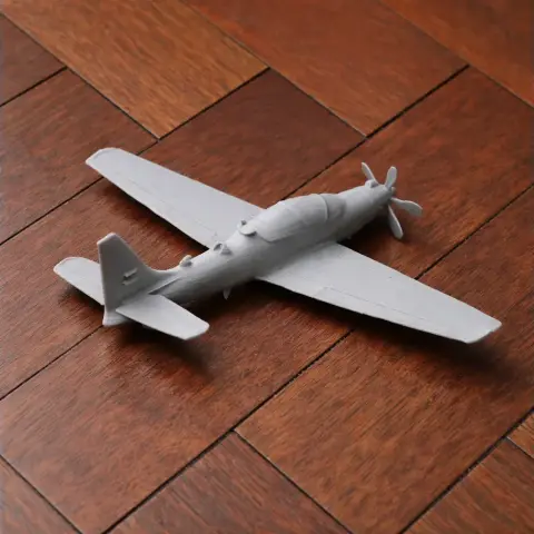 A 3D-printed model of an Embraer EMB 314 Super Tucano aircraft on a wooden surface.