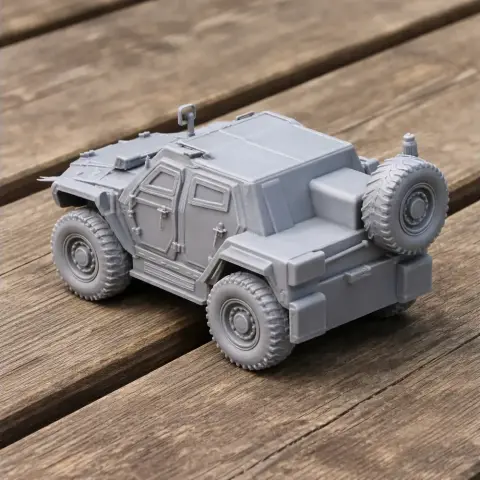 A detailed 3D-printed model of an Otokar Cobra II tank on a wooden surface.