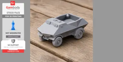 Gray 3D-printed model of an armored vehicle with angular design on a wooden surface.