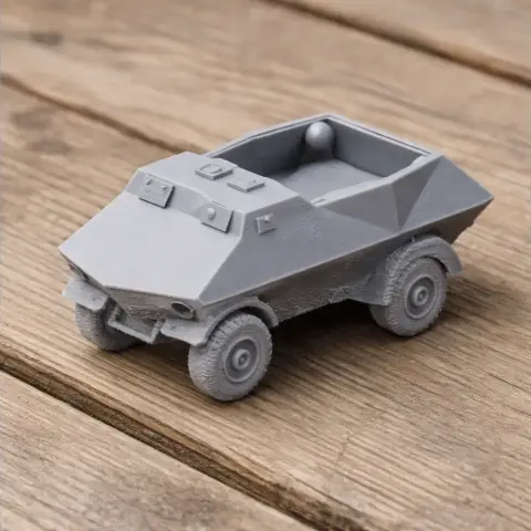 A small, angular, gray 3D-printed armored vehicle model on a wooden surface.