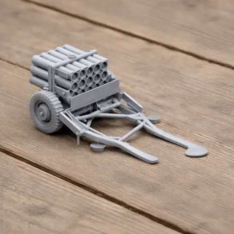 3D-printed model of a Pampero rocket launcher with multiple barrels and wheels on a wooden surface.