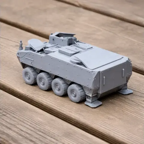 3D-printed model of a Pandur II tank on a wooden surface.