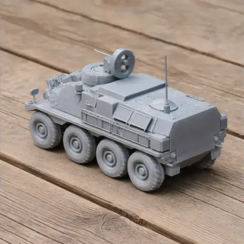Gray 3D-printed model of a Panhard VCR military vehicle on a wooden surface.