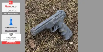 A 3D-printed Browning Buck Mark pistol prop lying on grass.