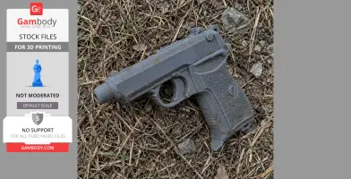 A 3D-printed gray model of a vintage pistol prop, placed on dry grass and rocks.