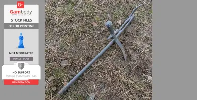A gray 3D-printed sword prop from Bloodborne, lying on dry grass and dirt.