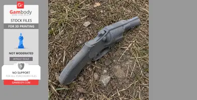 Gray 3D-printed Colt Detective Special prop lying on grassy, rocky ground.