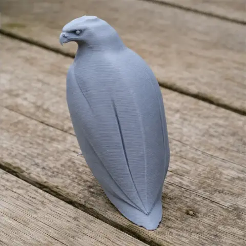 A 3D-printed model of a prehistoric barred hawk, standing on a wooden surface.