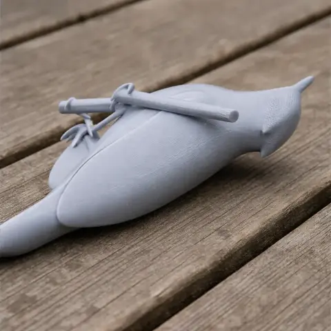 A 3D printed model of a bird with a set of life-like arrows on its back, resting on a wooden surface.