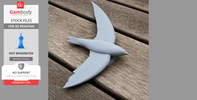 Gray 3D-printed model of a prehistoric bird with outstretched wings, resting on wooden panels.