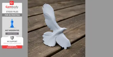 A 3D printed model of a bird with outstretched wings, placed on a wooden surface.