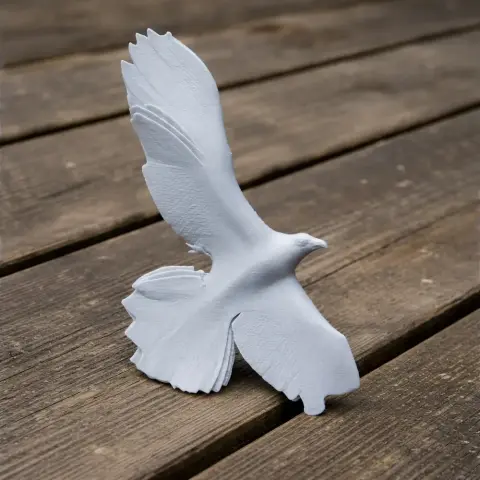 A 3D-printed model of a bird in flight, perched on wooden planks.
