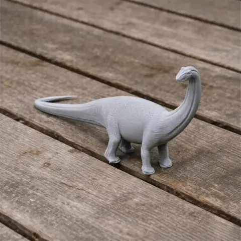 A 3D printed model of a Baurutitan dinosaur on a wooden surface.