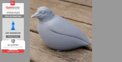 Gray 3D printed model of a bird, resembling an antpitta, placed on a wooden surface.