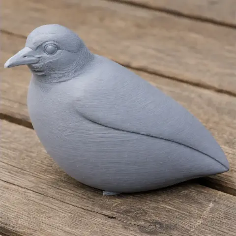 3D printed gray bird figurine with smooth texture, resting on a wooden surface.
