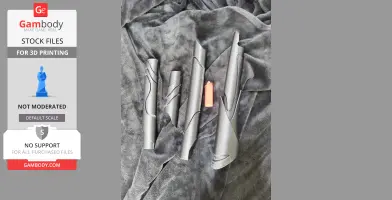 Disassembled dark 3D-printed parts of a Chitauri staff on a textured gray fabric.