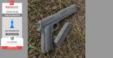 A 3D-printed Colt M1900 prop and magazine lying on grass and dirt, unpainted and gray in color.