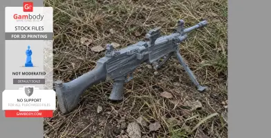 A 3D-printed model of a gun prop rests on grass, featuring a bipod and detailed design.