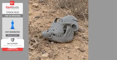 Gray 3D-printed Kryptops dinosaur skull replica, displayed on sandy ground with sparse vegetation.