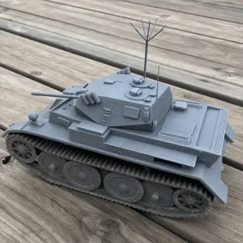 A detailed 3D-printed model of a Panzer II Luchs tank on a wooden surface.